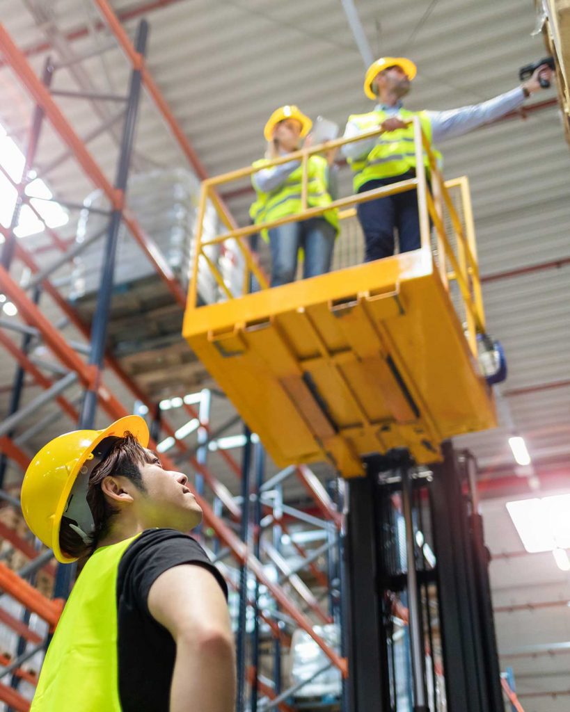 Forklift operators working on aerial boom lift truck