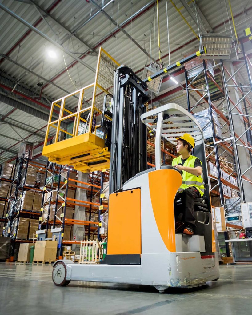 Person operating forklift in a warehouse