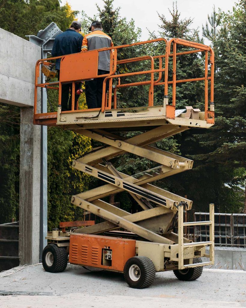 Man working on scissor lift