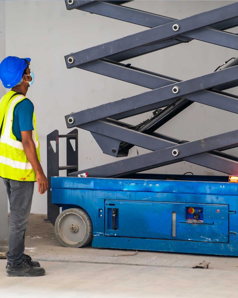 forklift operator checking scissor lift