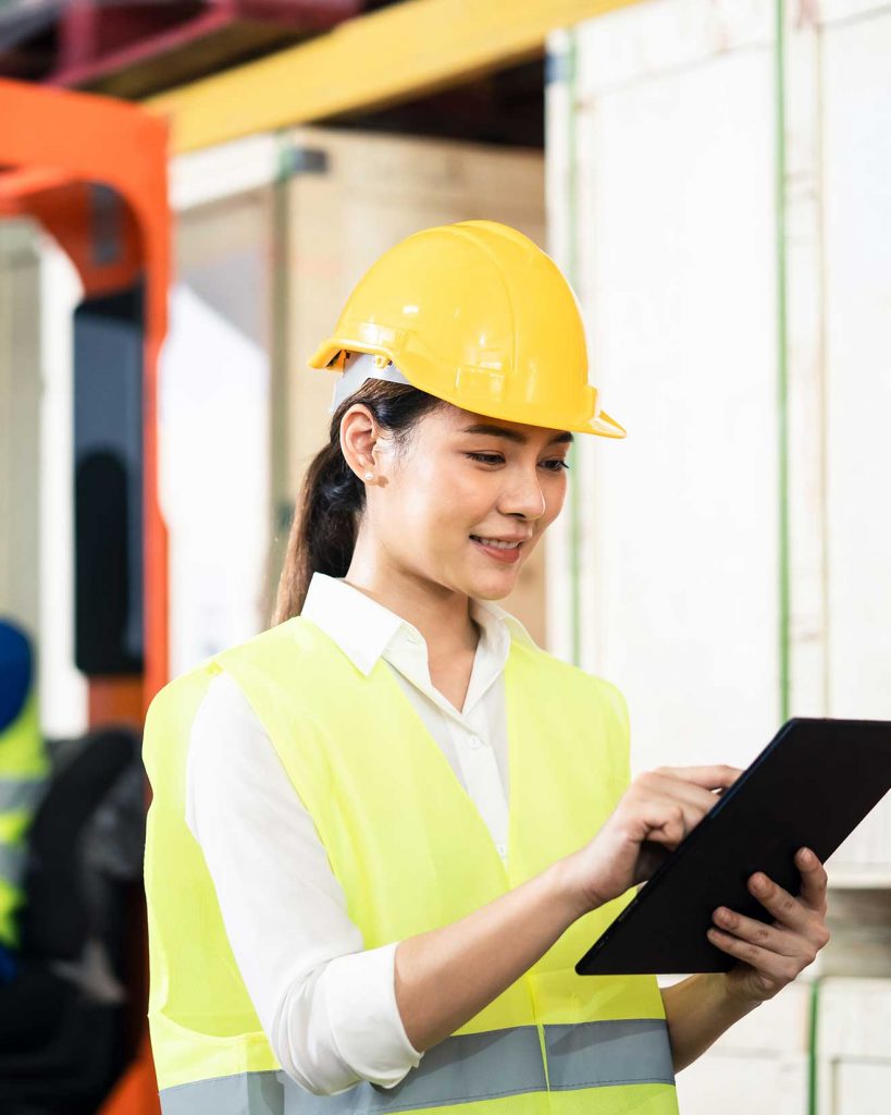 Female forklift driver holding a tablet